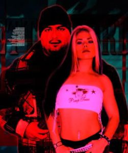 Man and woman with intense red lighting, posing confidently together.