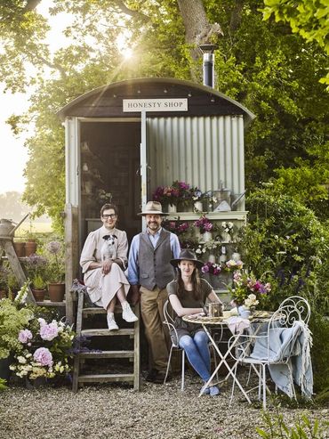 Three people sitting out side of the honesty shop on Ash Farm Dorset