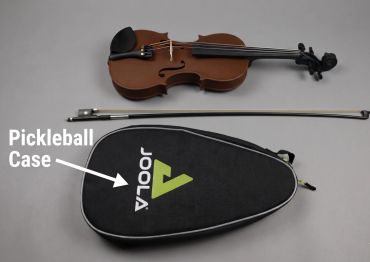 3d-printed Violin and bow above a pickleball case.