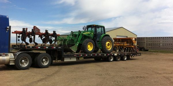 A tractor on a flatbed trailer