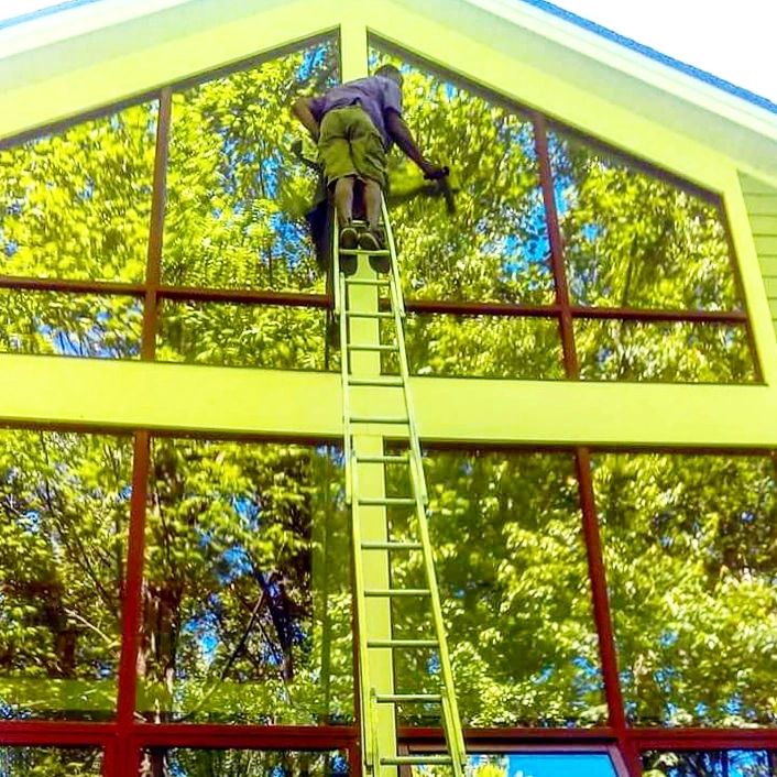 Residential  window cleaning in a house in Towson Maryland. Washing the glass 2 stories high.