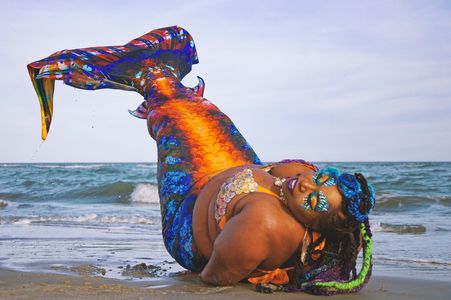 Mermaid Chè lays fin up at the shore. Photo by Your Rouge Photography.