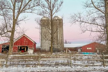 Farm silos in winter landscape.