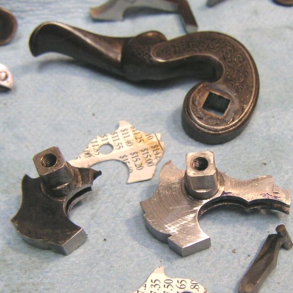 Intricately designed antique metal components on a cloth.