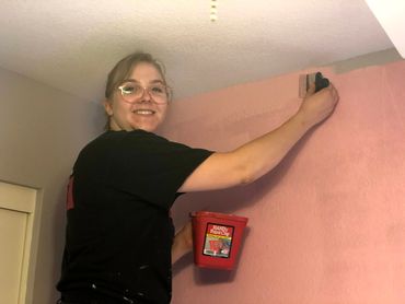 Chloe Spackman paints bedrooms and accent walls.