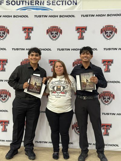 Two young men and a woman posing with awards at Tustin High School.