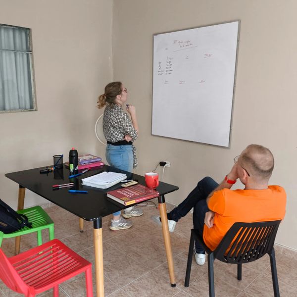 Small group learning Spanish together in a bright, modern classroom in Cali.