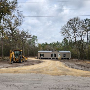 driveway pad lime rock fill dirt home house backhoe tractor