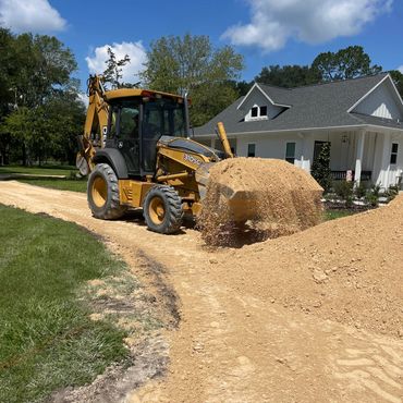 backhoe tractor lime rock driveway