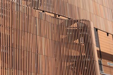 Vertically mounted terracotta louvers in varied fired-clay tones at Tongchuan Museum
