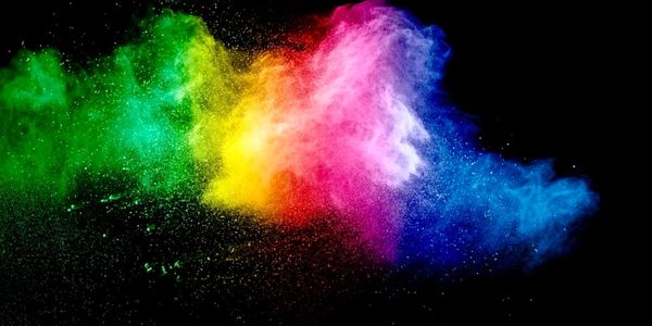 Colorful powder explosion against black background.