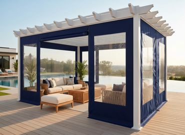 A lakeside deck with a pergola wrapped in a Robie custom set of blue panels keeping the weather out.