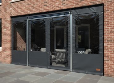 Front windows of a bakery with Canvas Enclosure Panels handing in front.