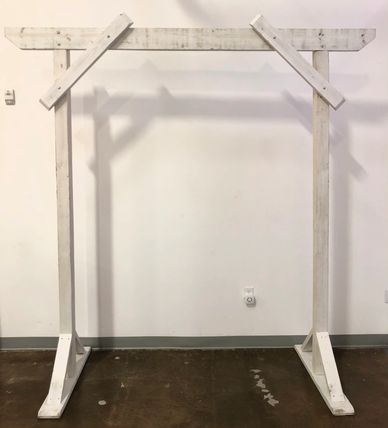 Simple white wood wedding arch