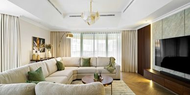 Modern living room with a large sectional sofa and a flat-screen TV.