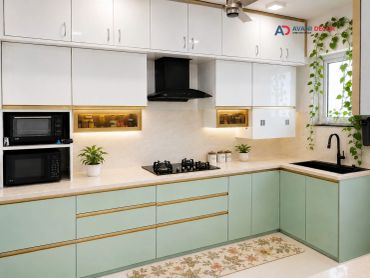 Modern kitchen with white and mint cabinets, black appliances, and plants.