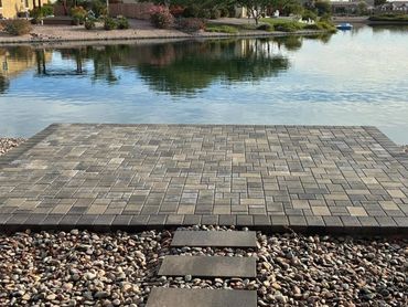 “Paver platform by the lake — residential exterior hardscape project in Arizona.”