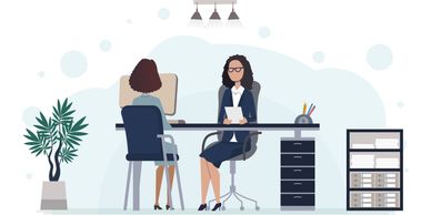 Two women having a professional meeting in an office setting.