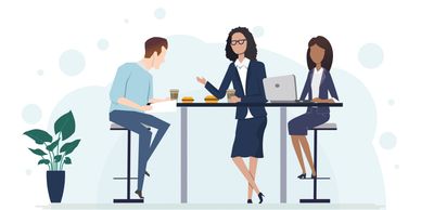 Three professionals having a business meeting over coffee at a high table.