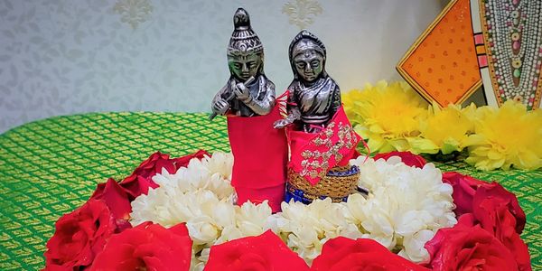Ram and Sita idol with flowers