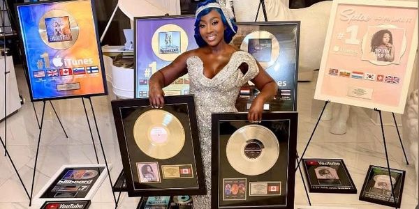 Spice holding her plaques after certification.