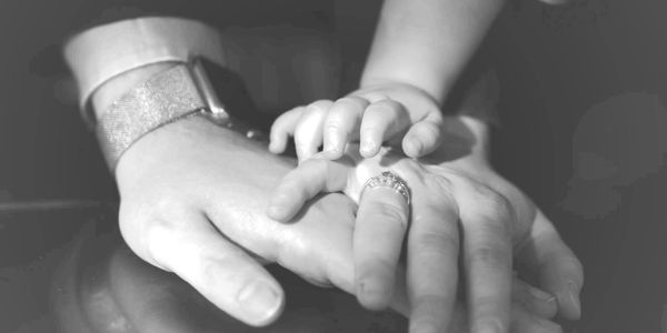Shipley & Swain attorneys holding hands with their child