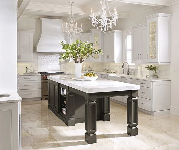Stylish open kitchen with dark wood flooring, white cabinets, and quartz countertops