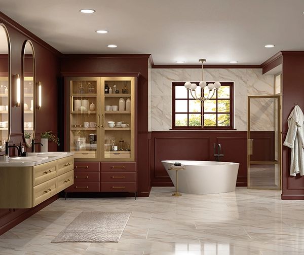 Elegant master bathroom featuring marble-look porcelain flooring, freestanding soaking tub