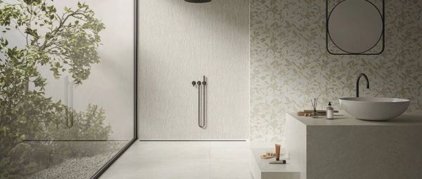 Minimalist luxury bathroom with large-format porcelain tile, walk-in shower, and nature-inspired