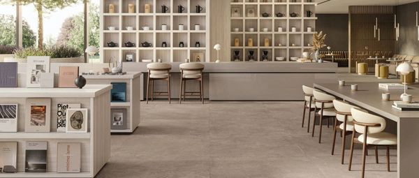 Minimalist living space with Supergres Whisper Earth porcelain tile flooring in a natural earth tone by Floors N More Direct – Naples, FL tile showroom