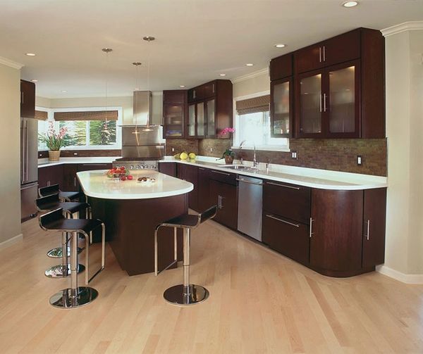 Contemporary kitchen with cherry wood cabinetry, light tile flooring, and modern lighting