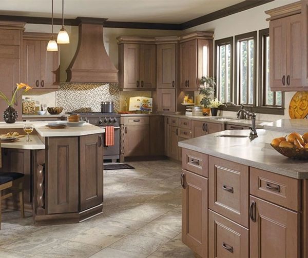 Traditional kitchen with cherry wood cabinets, neutral tile flooring, and granite countertops