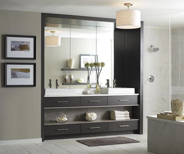 Contemporary bathroom with dark wood vanity, dual sinks, and light tile flooring by Floors N More