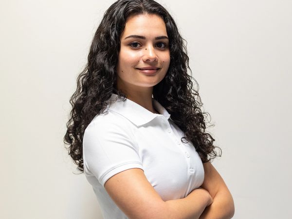 a smiling woman wearing a white shirt