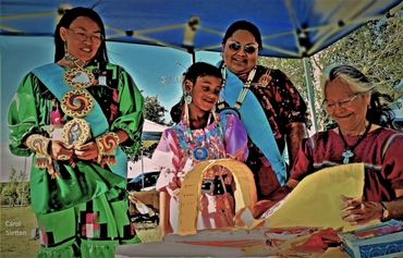 Bonnie Lewis demonstrates the making of a cradle board to current and future scholarship recipients.