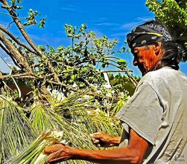 Apache man demonstrates building of a traditional Apache home or Gowa.