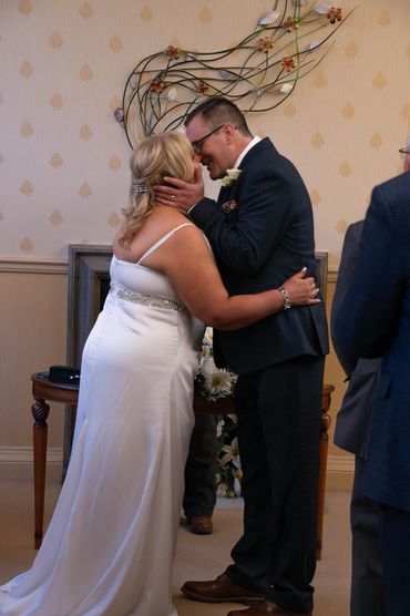 Bride and groom share a loving moment during their wedding ceremony.
