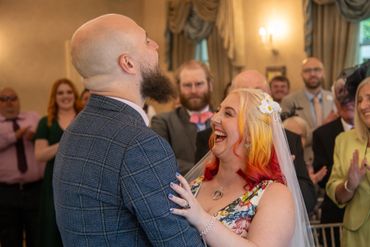 A joyful bride and groom share a happy moment during their wedding ceremony.