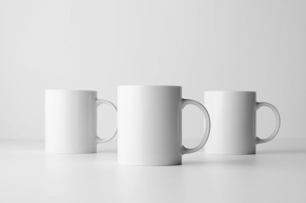 Three white cups in the row.