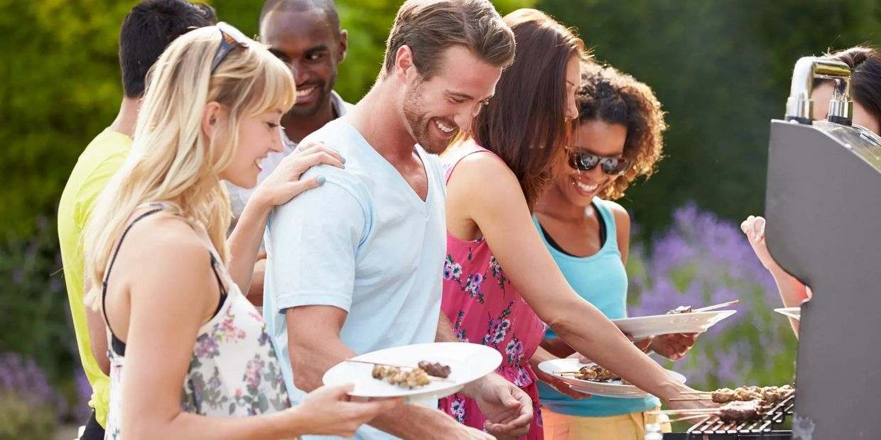 Friends enjoying a barbecue outdoors.
