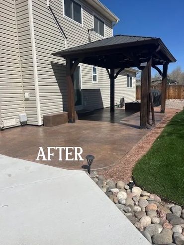 A newly renovated patio with a pergola and clean landscaping.