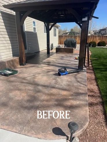 Empty patio with a covered pergola and lawn beside it.