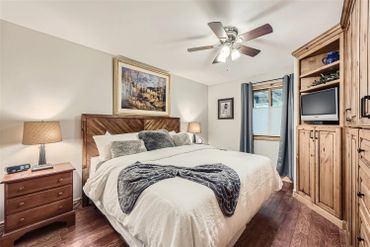 Cozy bedroom with wooden furniture and soft lighting.