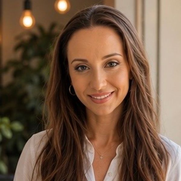 Portrait of a smiling woman with long hair indoors.