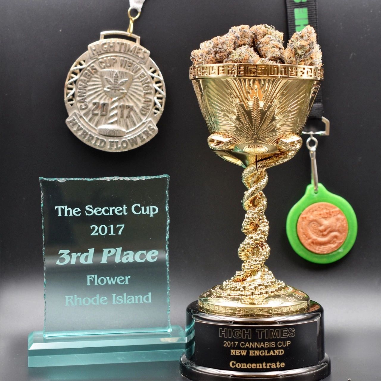 Trophy, medal, and plaque showing placement in different cannabis events