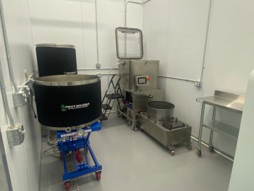 Industrial cannabis processing equipment in a clean room.