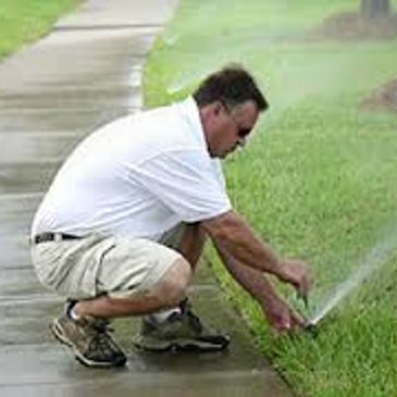 Dennis Hepler HomeTown landscape and irrigation working on an adjustment in Trophy Club Texas 76262