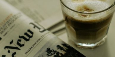 Photo of a New York Times newspaper and a coffee