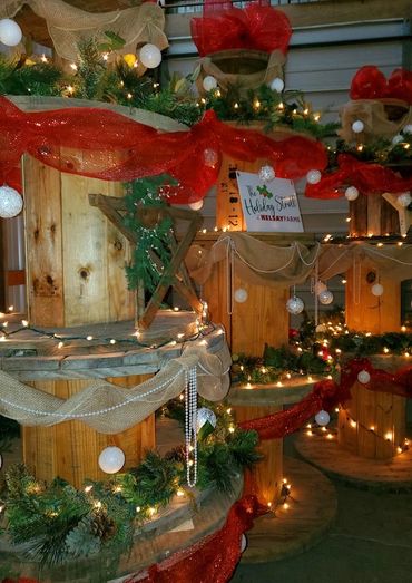Festive holiday decorations with lights, garlands, and red ribbons at Kelsay Farms.