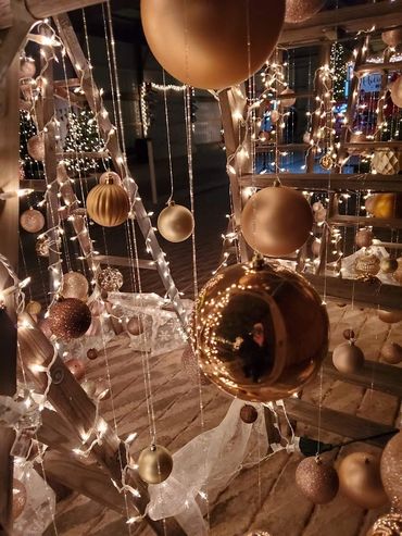 Warm golden Christmas ornaments and lights create a festive holiday display.